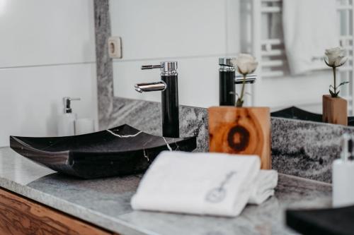 a bathroom counter with a sink with a sink at Einzigartig in Kuchl
