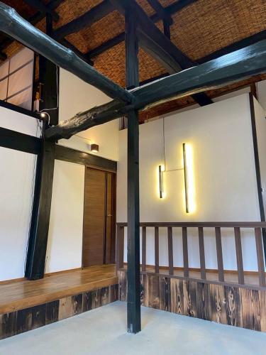 a room with two lights on the wall at The Kominka-house Olive in Sano