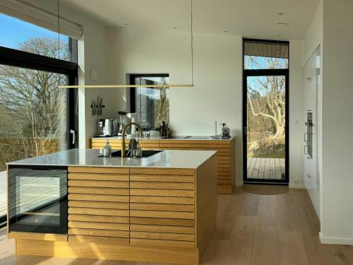 a kitchen with a sink and a counter top at Summer House On Hillside Plot By Sejerø Bay in Fårevejle