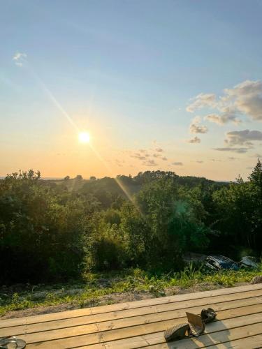 a view of the sunset from the deck of a house at Summer House On Hillside Plot By Sejerø Bay in Fårevejle