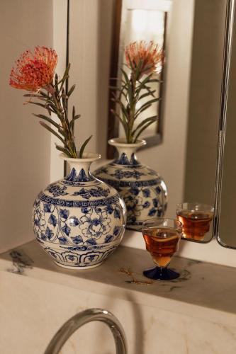 two blue and white vases on a counter with a mirror at Le Pigalle, a Member of Design Hotels in Paris
