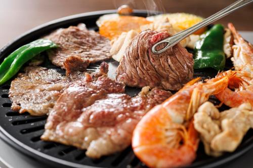 a plate of food with meat and vegetables on it at YATSUGATAKE KOGEN RESORT in Hokuto