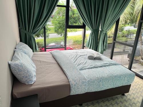a bed in front of a window with curtains at Puzzle House in Taiping