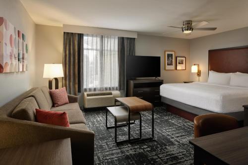 a hotel room with a bed and a couch at Homewood Suites by Hilton Columbus OSU, OH in Columbus