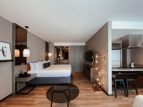 a hotel room with a bed and a kitchen at Hinode Hills Niseko Village in Niseko