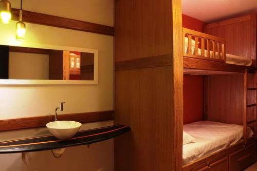 a bathroom with a sink and a bunk bed at Pousada Lazúli in Macaé