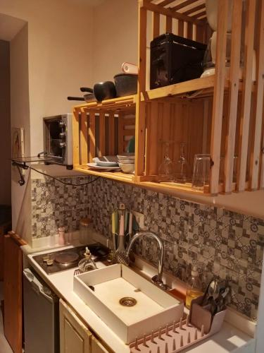 a kitchen with a sink and a counter top at Jardin de bougainvillier in Sfax