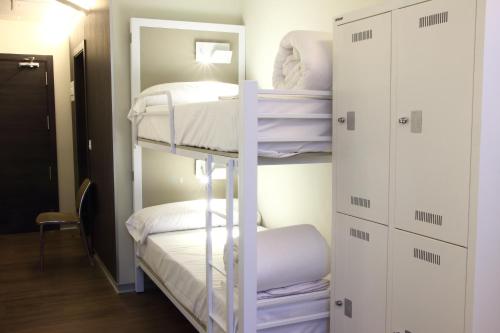 a bedroom with a bed and a desk at Poshtel Bilbao - Premium Hostel in Bilbao
