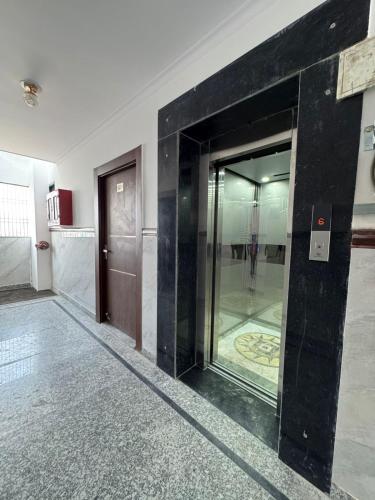 a lobby with a glass door in a building at Sukoon Stays in Noida