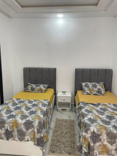 two beds sitting next to each other in a room at Villa Assef in Midoun