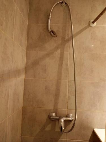 a shower with a shower head in a bathroom at Charmant studio à Sfax in Sfax