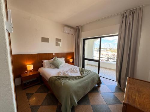 a bedroom with a bed and a large window at Cerro Atlantico by Umbral in Albufeira