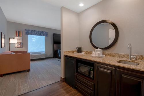 a bathroom with a sink and a mirror at Hampton Inn & Suites Harvey New Orleans Westbank in Harvey