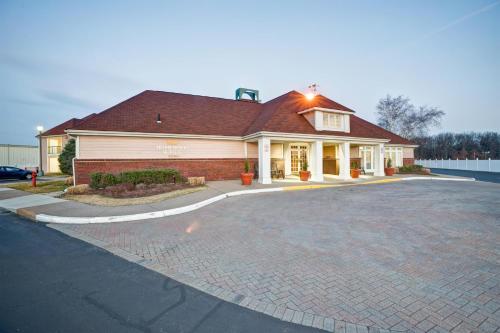 a house with a driveway in front of it at Homewood Suites by Hilton Windsor Locks Hartford in Windsor Locks