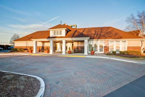 a house with a large driveway in front of it at Homewood Suites by Hilton Windsor Locks Hartford in Windsor Locks