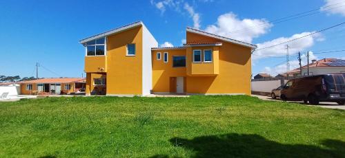 a yellow house with a green yard at Wake up with the Sea Breeze- House with pool AP1 in Lavra
