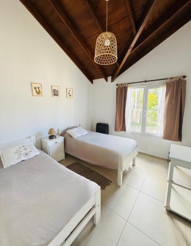 a bedroom with two beds and a large window at Casa Arroyo - Esquel in Esquel