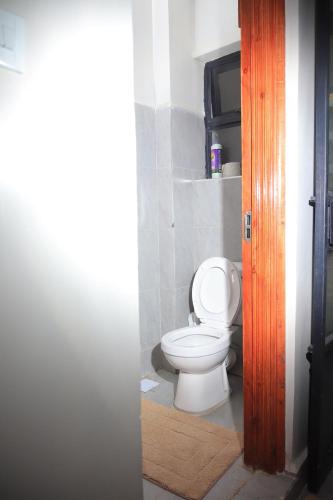 a bathroom with a white toilet in a room at Azure View Studio with pool in Kiahuria