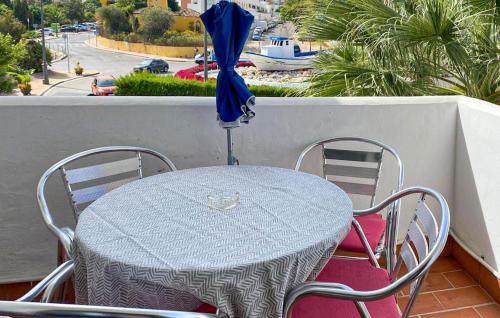 a table and chairs with an umbrella on a balcony at 2 Bedroom Lovely Apartment In Estepona in Estepona