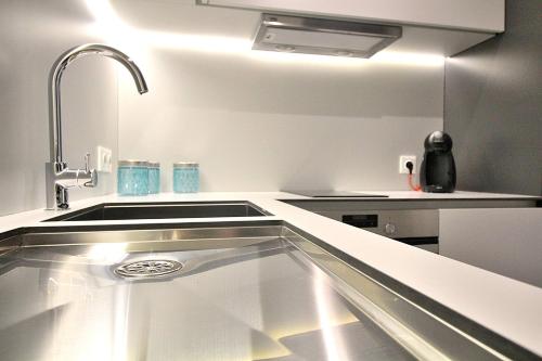 a kitchen with a stainless steel kitchen sink at RestOnDouro Oporto Studio in Valbom