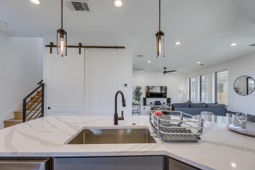 a kitchen with a sink and a living room at Chic Austin House w/ Spacious Backyard & Hammock in Austin
