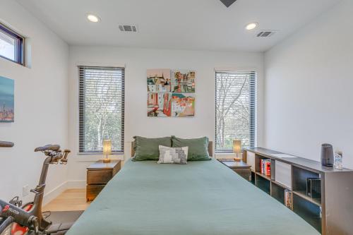 a large bed in a room with two windows at Chic Austin House w/ Spacious Backyard & Hammock in Austin