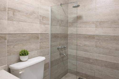 a bathroom with a toilet and a glass shower at Departamento moderno, equipado full en vicente López ,ubicacion inmejorable a 100 metros del tren in Florida