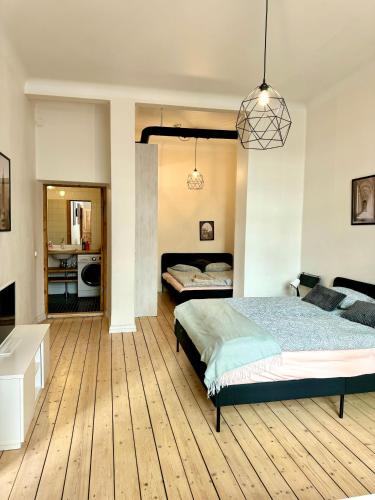 a large bedroom with two beds and a bathroom at Downtown Townhouse! in Helsinki