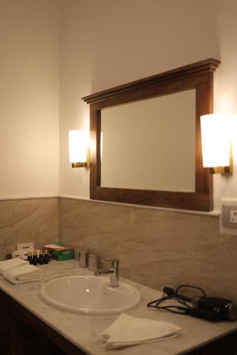 a bathroom with a sink and a mirror at JD Tara Resort in Ranakpur