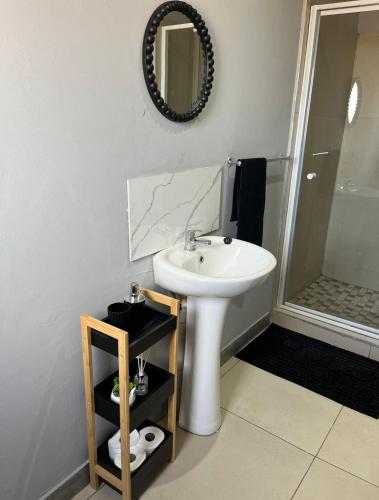 a bathroom with a sink and a mirror at Cubes Ledig Luxury Apartments in Ledig