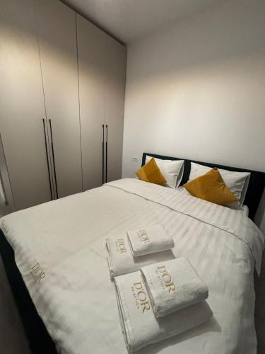 a bedroom with a bed with towels on it at The Urban Line by D'or Selection in Bucharest