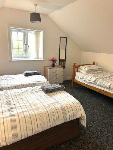 a bedroom with two beds and a window at Salmon Leap Hotel in Whitby