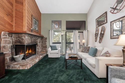 a living room with a couch and a fireplace at Sun Song 3F in Fraser