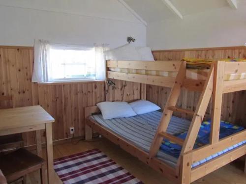 a bedroom with a bunk bed and a desk at Stuga1-6 Dalskärs camping Badrum i Servicehus in Bergkvara