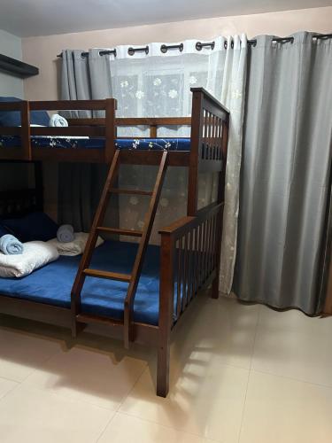 two bunk beds in a room with a window at R and RMI CONDOTEL in Baguio