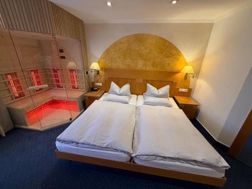 a bedroom with a large bed and a shower at Hotel gold Self-Check-In-Hotel Pfullendorf in Pfullendorf