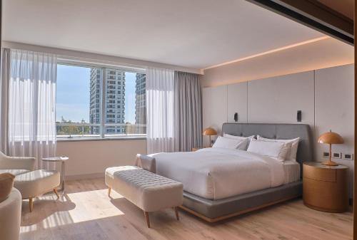 a bedroom with a large bed and a large window at Hilton Buenos Aires in Buenos Aires