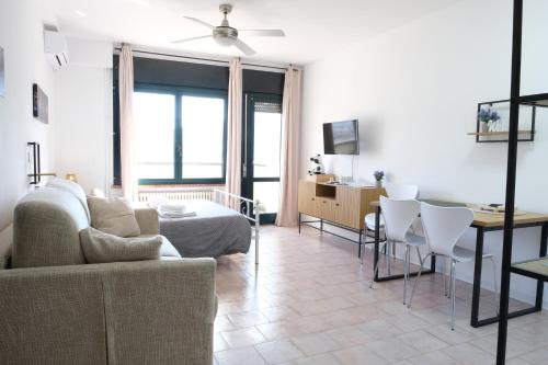 a living room with a couch and a table at Casa Segantini - Panorama Pool Apartment in Riva del Garda