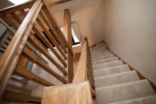 a staircase with wooden railings in a room at The Plough Inn in Stalisfield