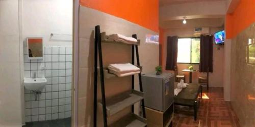 a bathroom with a sink and a toilet and a shower at Regina Hotel in Balasan