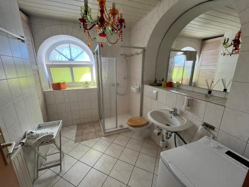 ein weißes Badezimmer mit Dusche und Waschbecken in der Unterkunft Grüne Villa in Kromlau