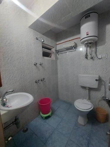 a bathroom with a toilet and a sink at Brightland Hotel near Mall Road - Stags entry not allowed in Shimla