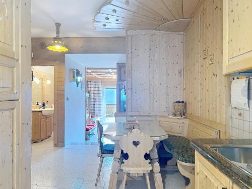 a kitchen with a table and a dining room at Lagorai Wood Apartment in Telve