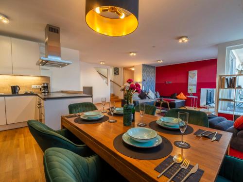 a dining room with a wooden table and green chairs at Premium Duplex 2BR for 6 with Balcony near City Museums Metro U3 U2 in Vienna