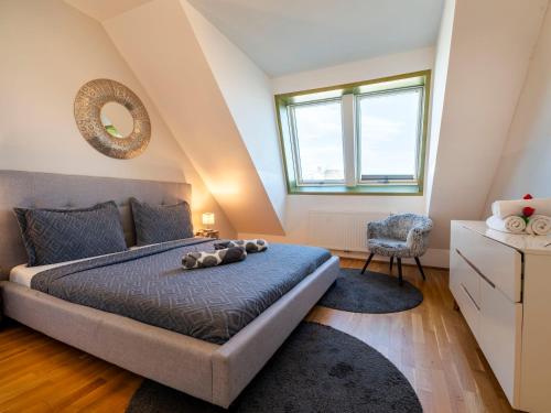 a bedroom with a large bed and a chair at Premium Duplex 2BR for 6 with Balcony near City Museums Metro U3 U2 in Vienna