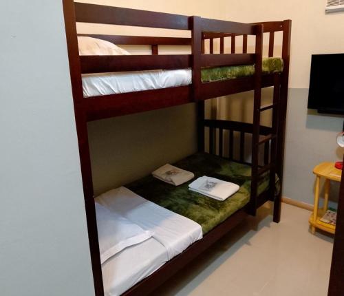 a couple of bunk beds in a room at Regina Hotel in Balasan