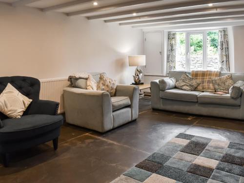 a living room with two chairs and a couch at Uk47758 - Horseshoe Cottage in Launceston