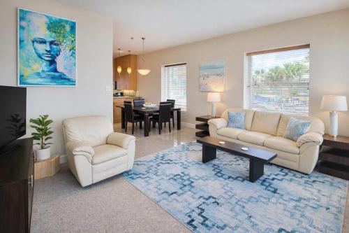 a living room with a couch and a table at 3 level luxury Beachlike Pool Killer Sunsets in South Padre Island