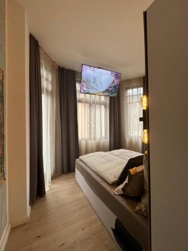 a bedroom with a bed with a tv on the ceiling at H-36 RESIDENCE - BRIGHT Collection in Koblenz