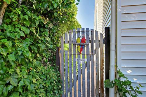 a fence with a bird on top of it at Birdcage - King Bed - Walk to CBD in West Hobart